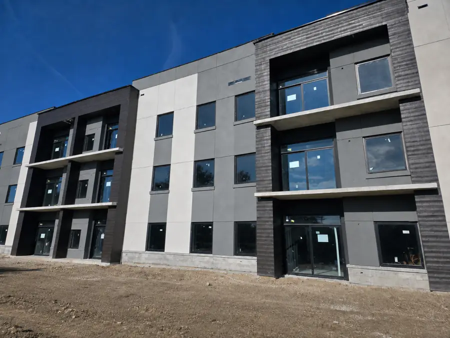 Ladona River Apartments in Niagara Falls with grey and white EIFS panels and recessed balconies
